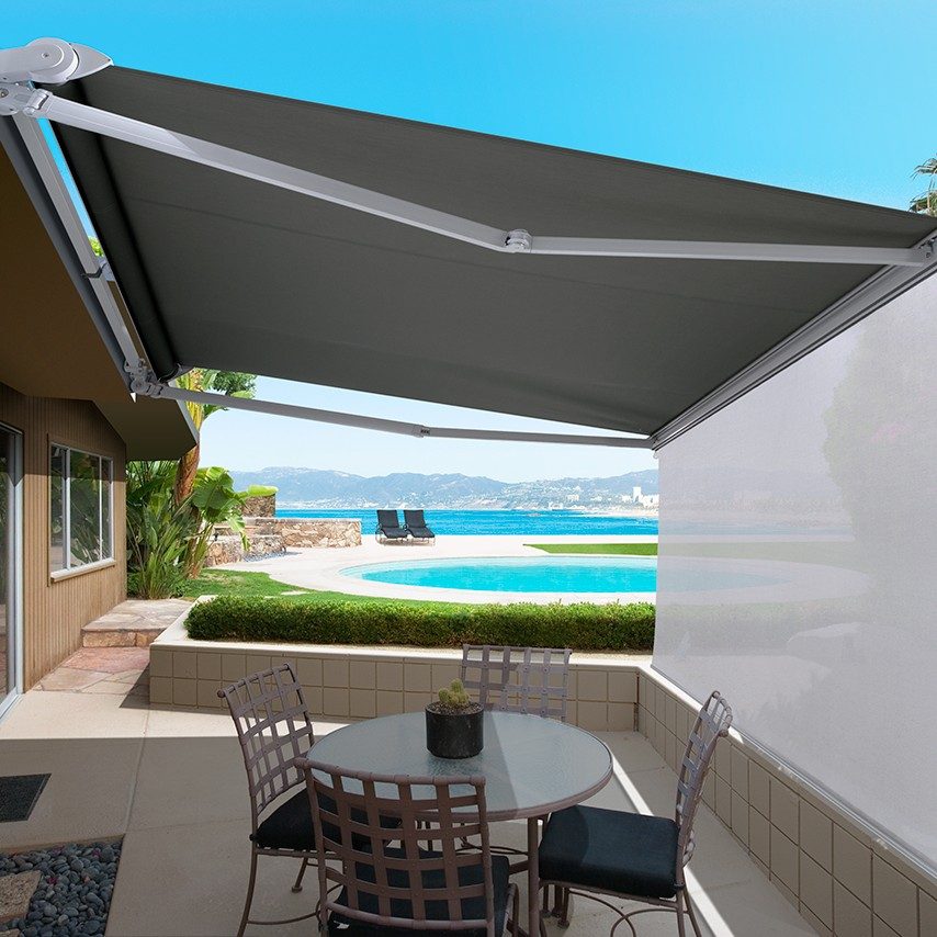 folding arm awnings extended over a patio with pool in background
