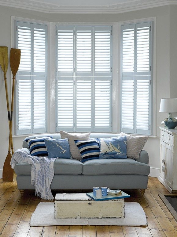 hinged shutters in a bay window