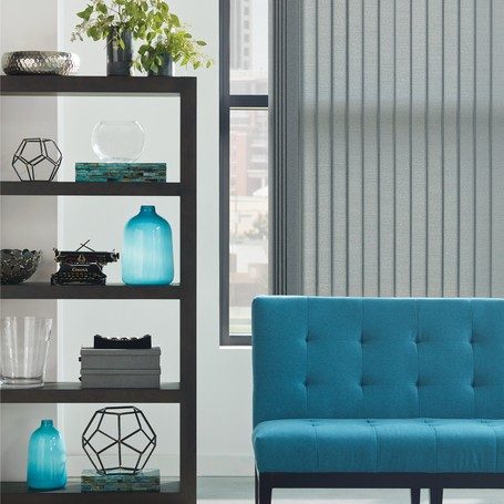 vertical blinds in an apartment with blue sofa