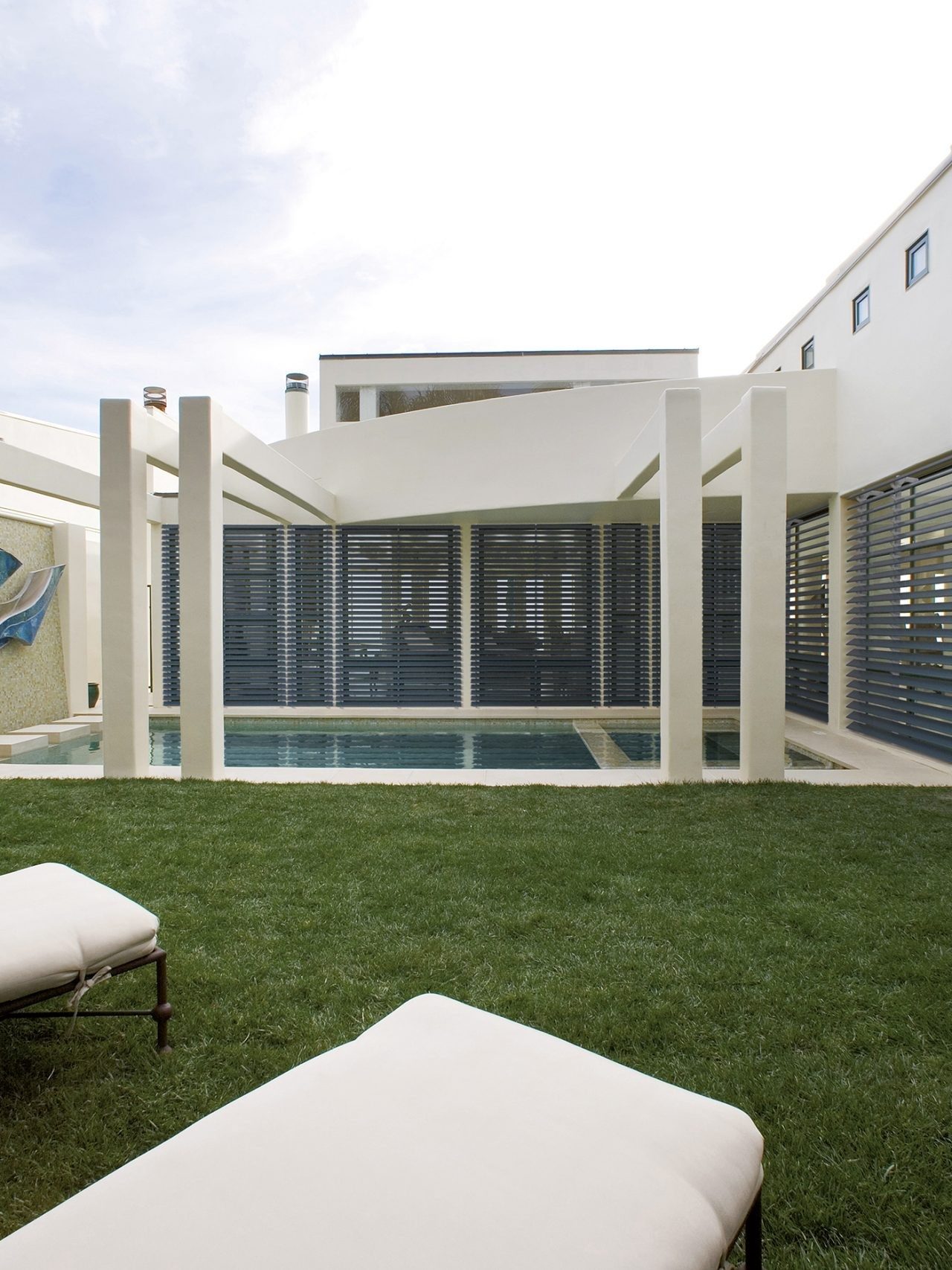 Outdoor pool area enclosed with aluminium shutters
