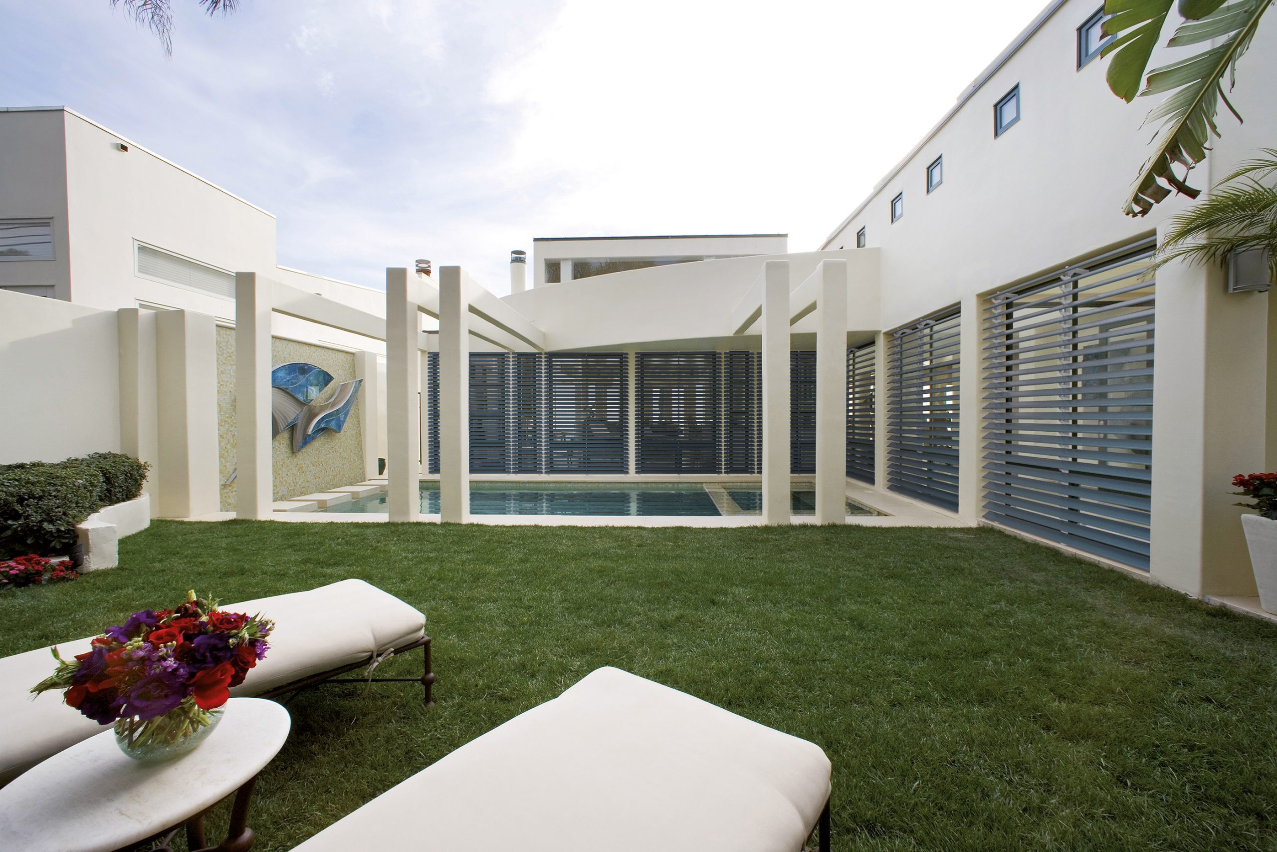 Outdoor pool area enclosed with aluminium shutters