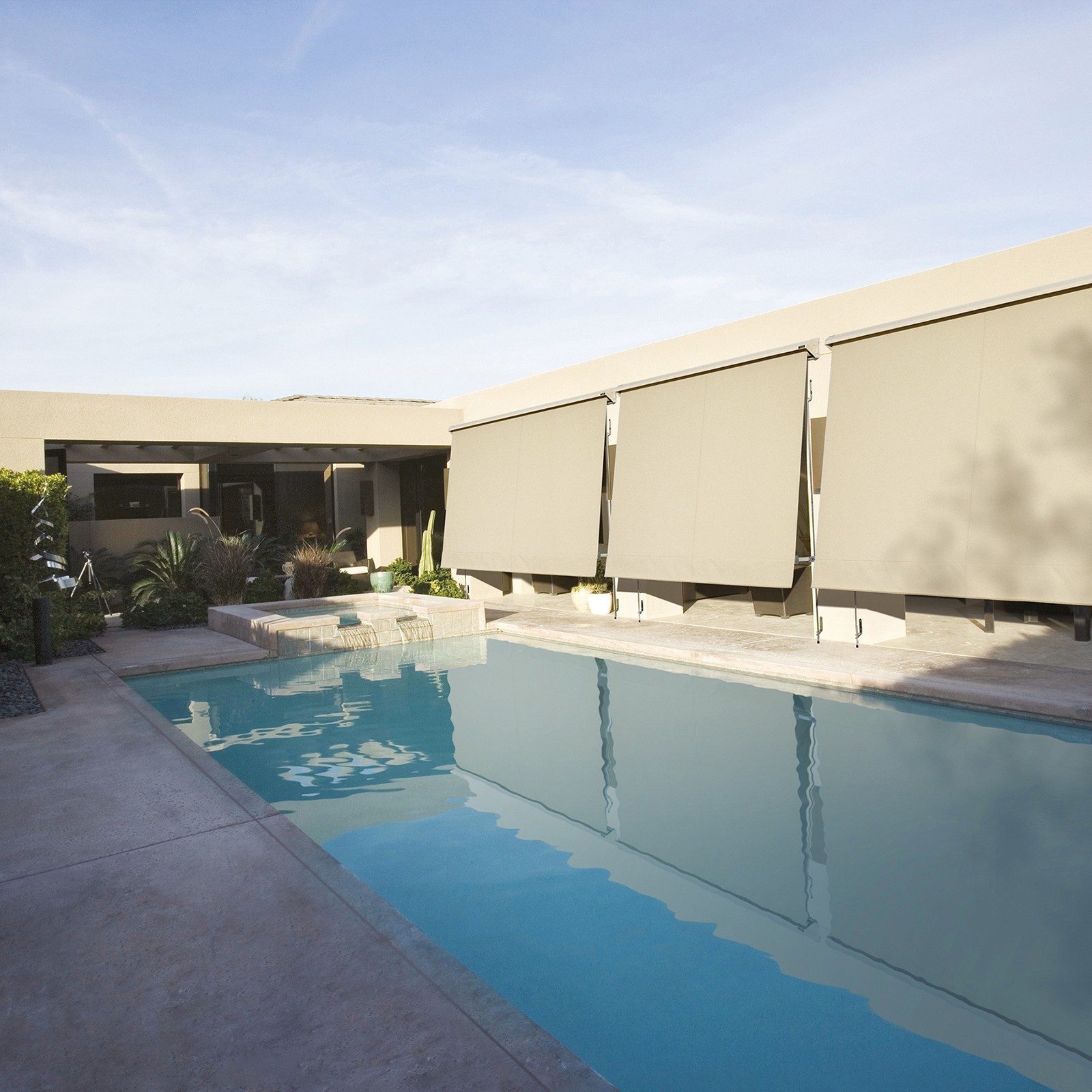 alpha screens extended to reduce sunlight into patio beside a pool