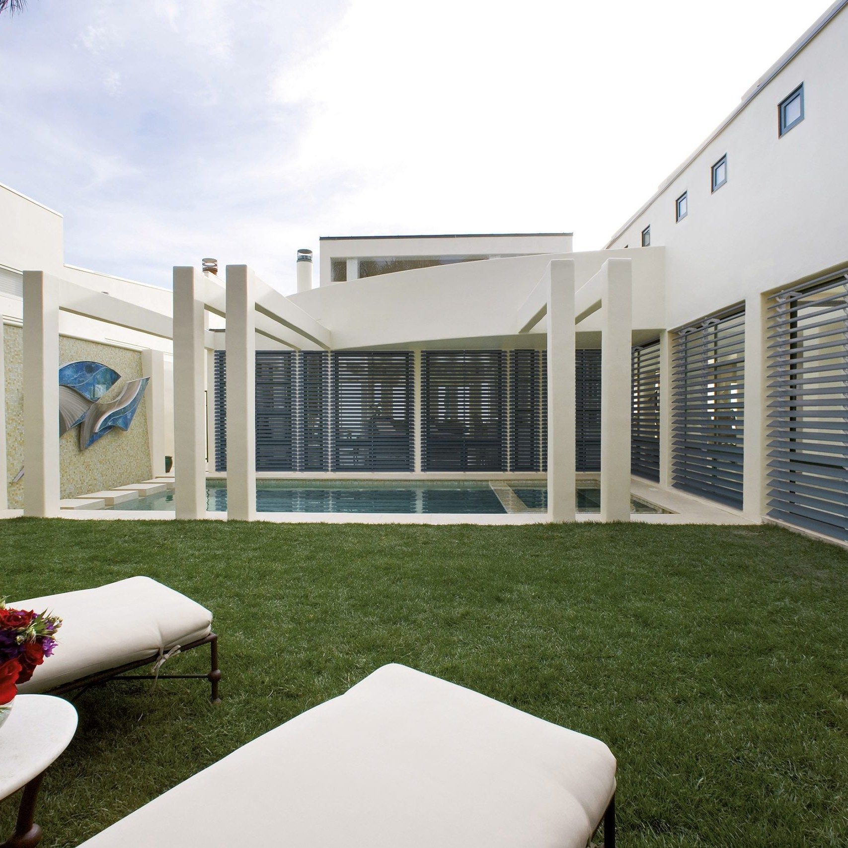 Outdoor pool area enclosed with aluminium shutters